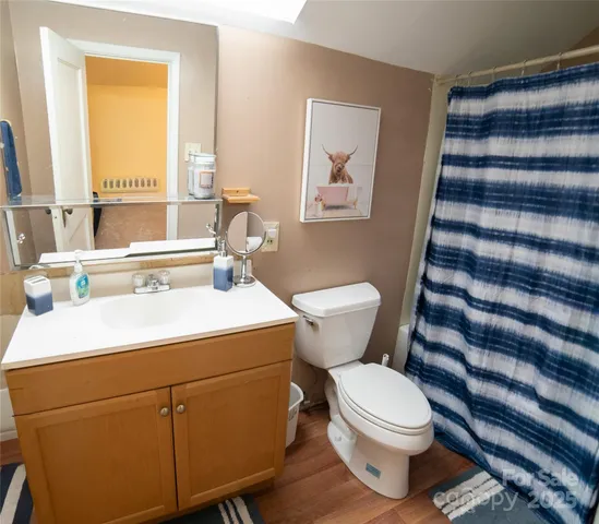 a large bed sitting in a bedroom next to a window