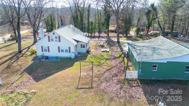 a view of a house with a yard and porch