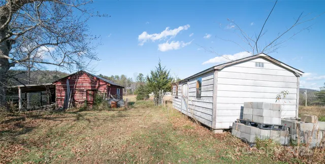 a view of a house with porch and garden