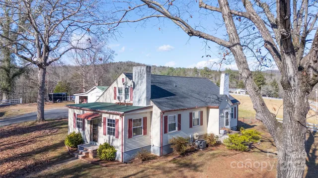 a view of a house with a yard garage and outdoor seating