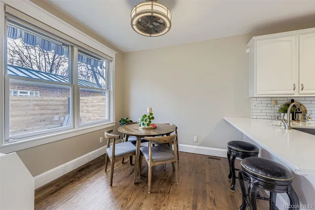 a dining room with furniture and window
