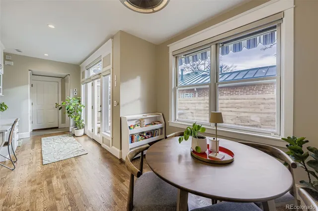 a view of a dining room with furniture and a potted plant