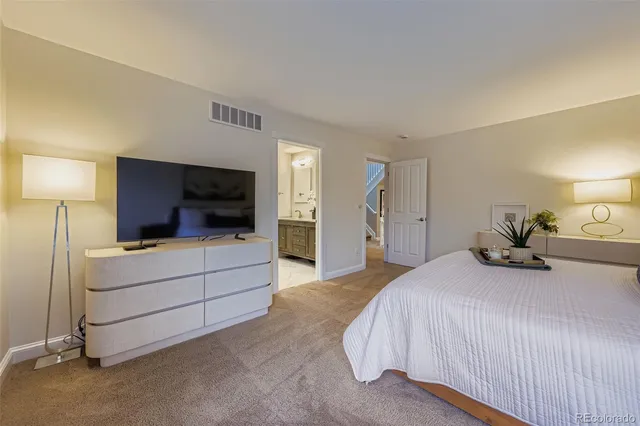 a bedroom with a bed and a television in it