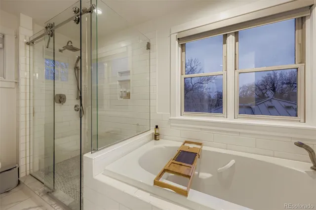 a bath room with a bath tub and a shower