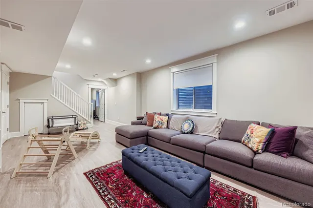 a living room with furniture ceiling fan and a rug