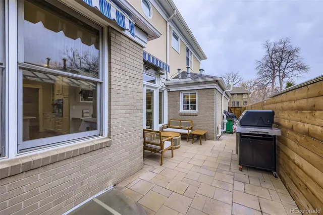 a backyard of a house with outdoor seating