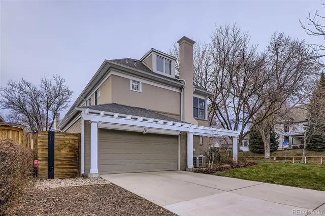 a view of a house with a large space and a large tree