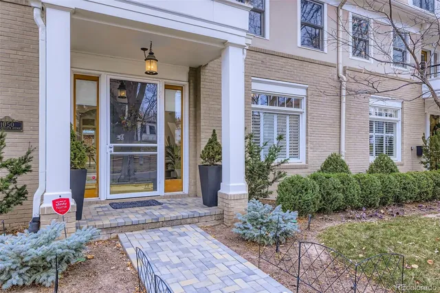 a view of a brick house with potted plants