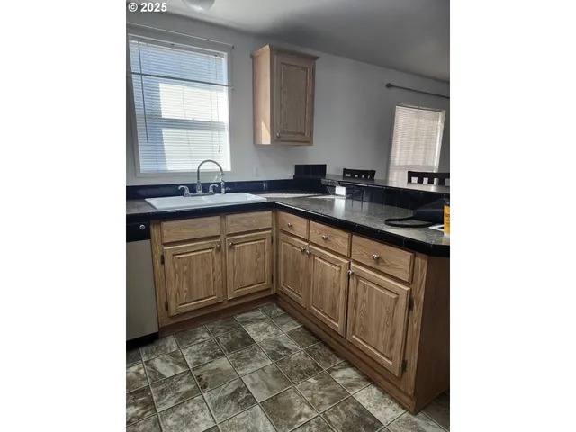 a kitchen with a sink and cabinets