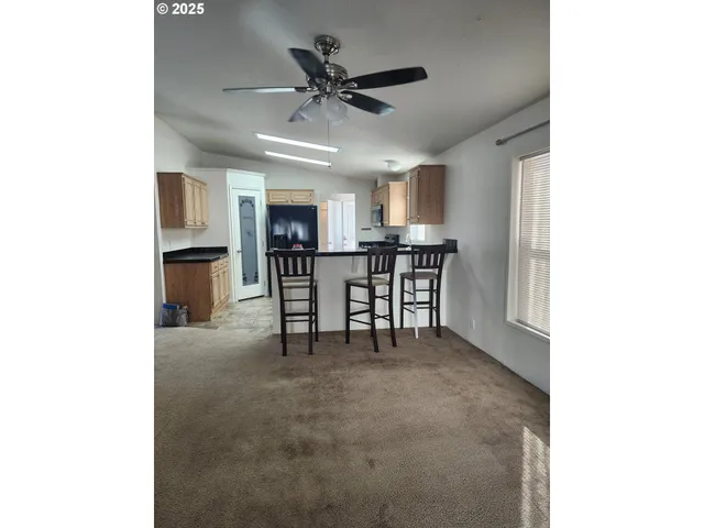 a view of a livingroom with furniture and a ceiling fan