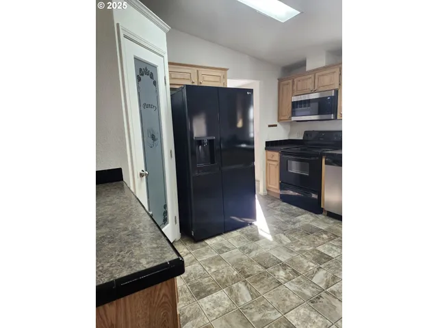 a view of a kitchen from the hallway