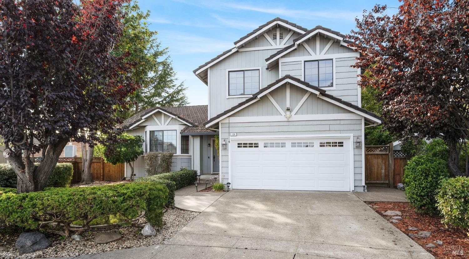 a view of house with garage and small yard