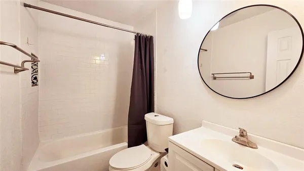 a bathroom with a sink toilet and a mirror