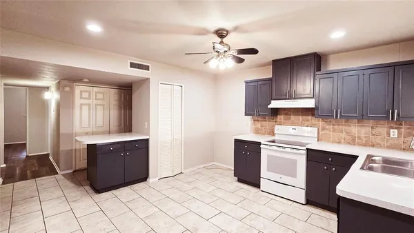 a kitchen with stainless steel appliances granite countertop a sink and dishwasher a refrigerator with wooden cabinets