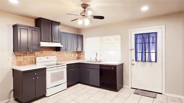 a kitchen with a sink cabinets and window