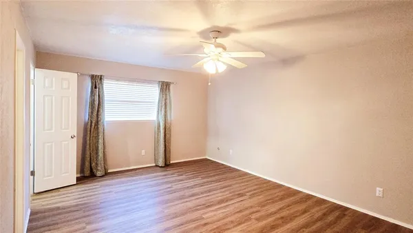 a view of a room with wooden floor and closet