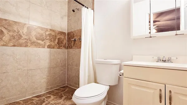 a bathroom with a toilet a sink and a shower