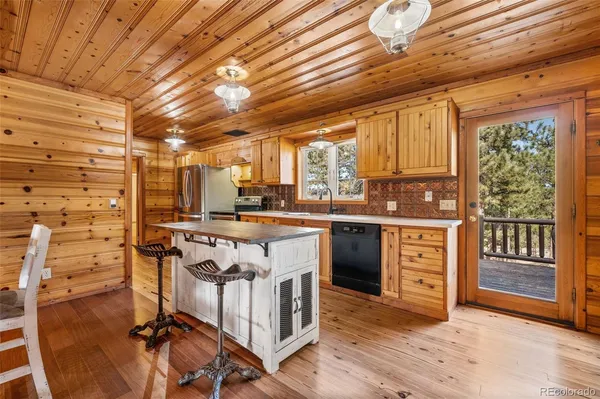a kitchen with stainless steel appliances granite countertop a stove and a refrigerator