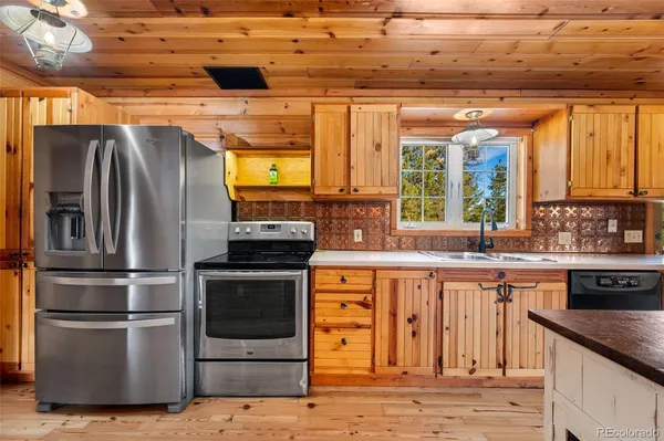 a spacious bedroom with a bed and wooden floor
