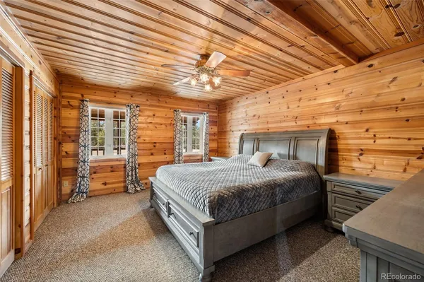 a bedroom with a large bed and a shower