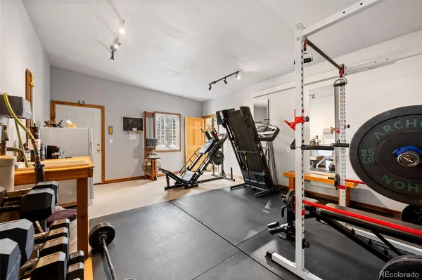 a work room with furniture and a flat screen tv