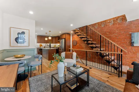a living room with furniture and kitchen view