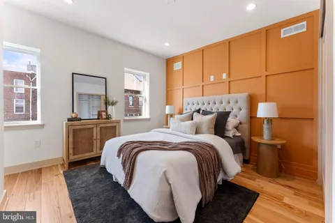 a bed room with a bed and a night stand