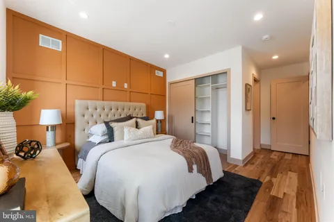 a bedroom with bed and a night stand