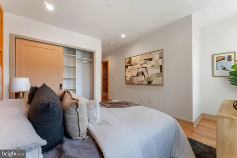 a bedroom with a bed and a couch