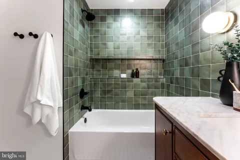 a bathroom with a bathtub and shower