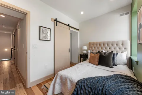 a bedroom with a bed and a mirror