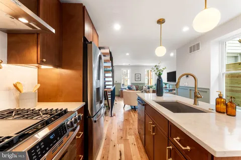 a kitchen with counter top space stove and sink