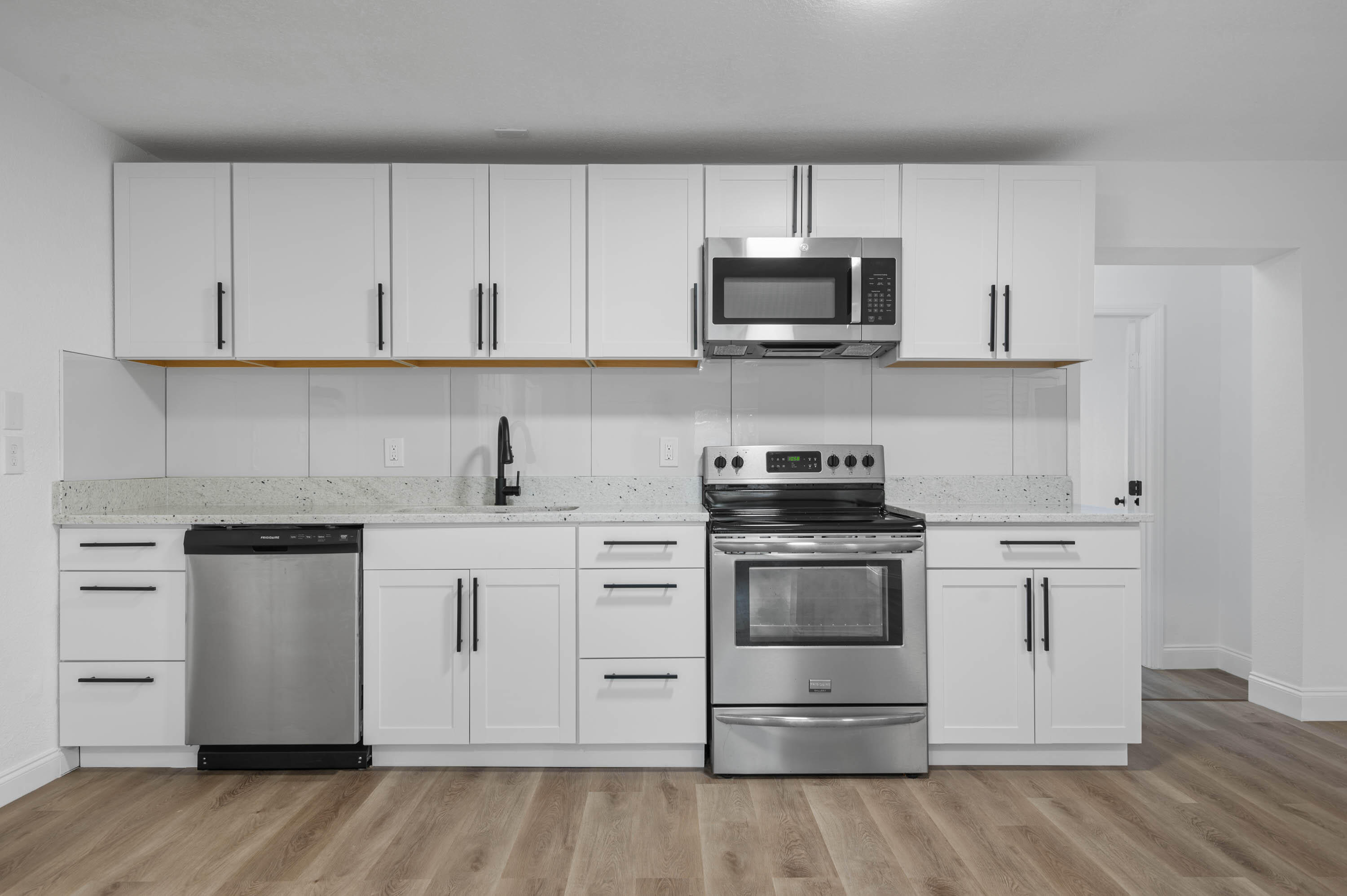 515 A Lane Cocoa, FL 32926 - Photo 13 of 31 a kitchen with white cabinets and stainless steel appliances