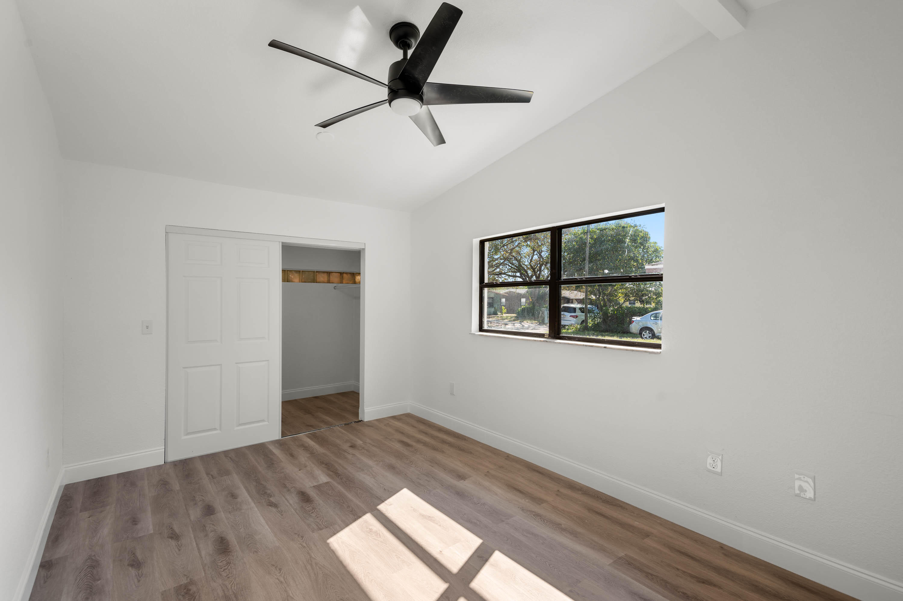 515 A Lane Cocoa, FL 32926 - Photo 15 of 31 an empty room with wooden floor and windows