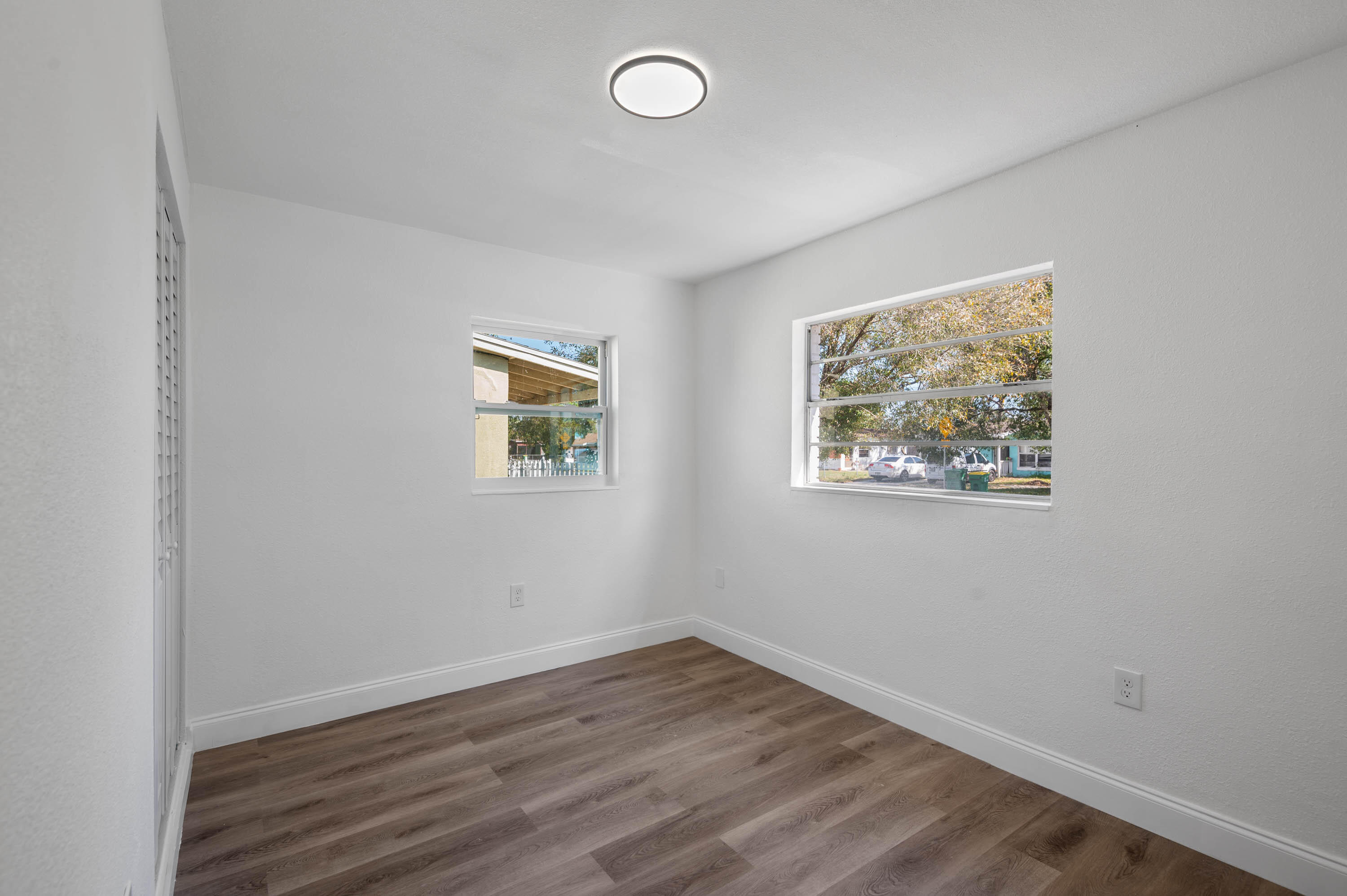 515 A Lane Cocoa, FL 32926 - Photo 17 of 31 an empty room with wooden floor and windows