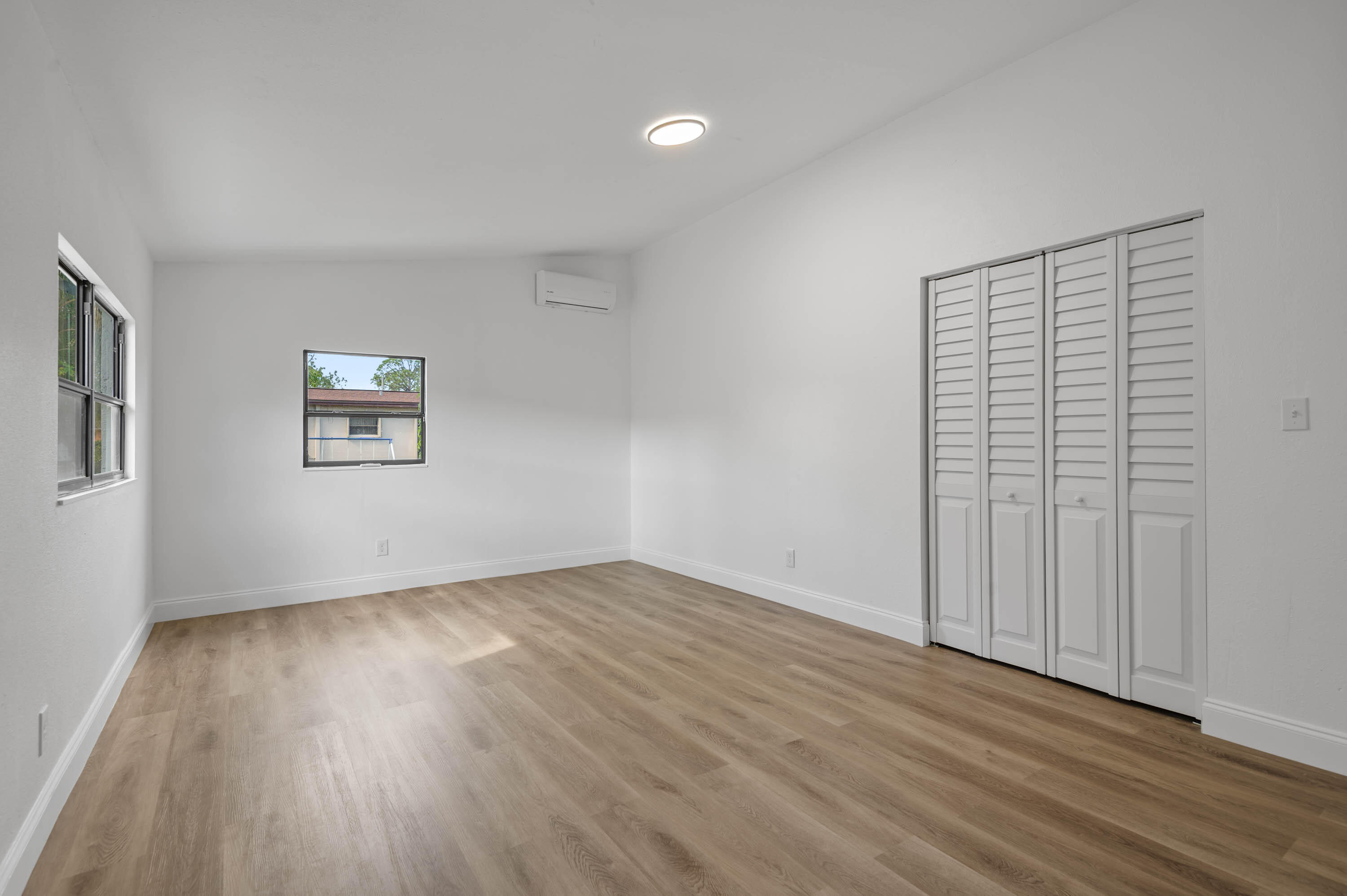 515 A Lane Cocoa, FL 32926 - Photo 24 of 31 an empty room with wooden floor and windows