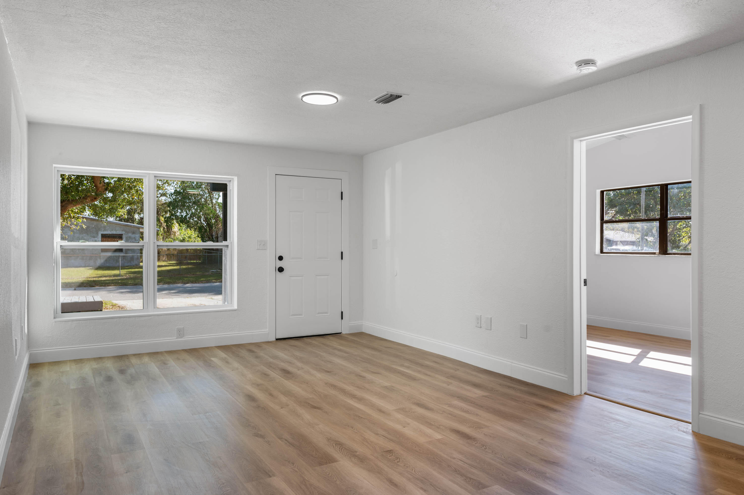 515 A Lane Cocoa, FL 32926 - Photo 3 of 31 an empty room with wooden floor and windows