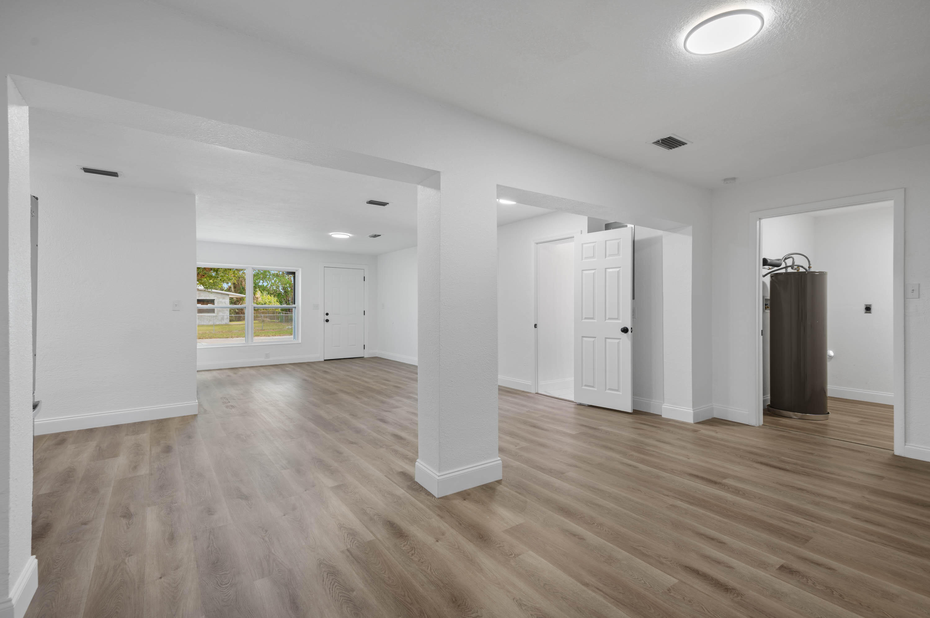 515 A Lane Cocoa, FL 32926 - Photo 4 of 31 wooden floor in an empty room with a window
