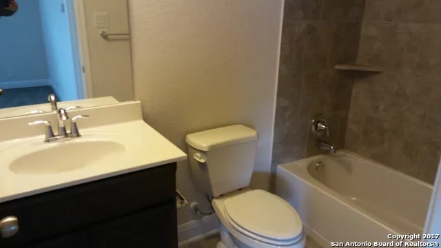 a bathroom with a sink a toilet and bathtub