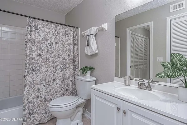 a bathroom with a toilet a sink and shower