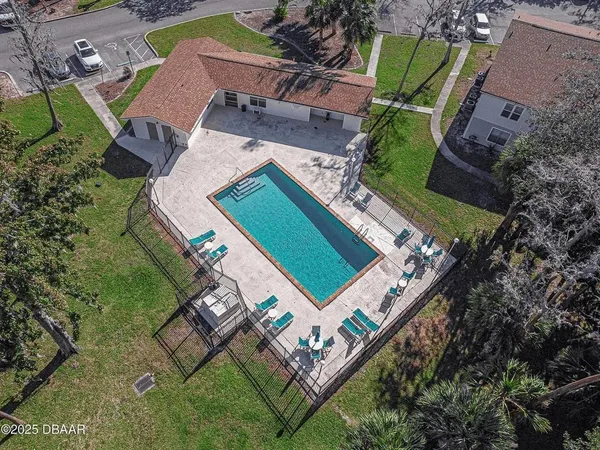 a view of a yard with plants and trees