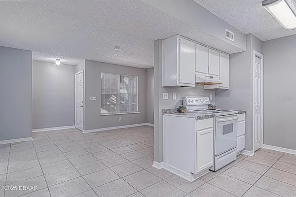 a kitchen with cabinets appliances and a window