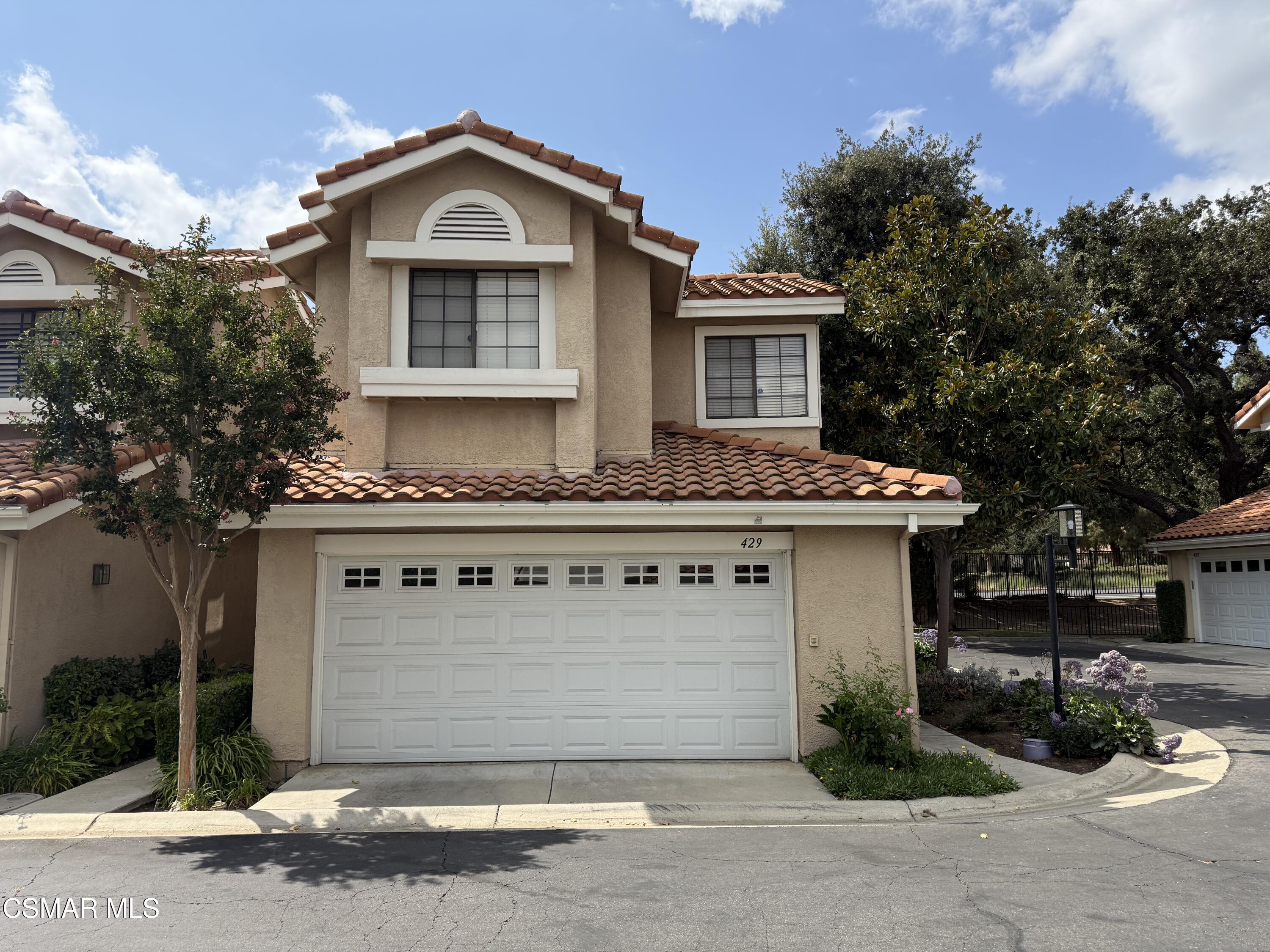 429 Dante Way Oak Park, CA 91377 - Photo 2 of 18 a front view of a house with a garden