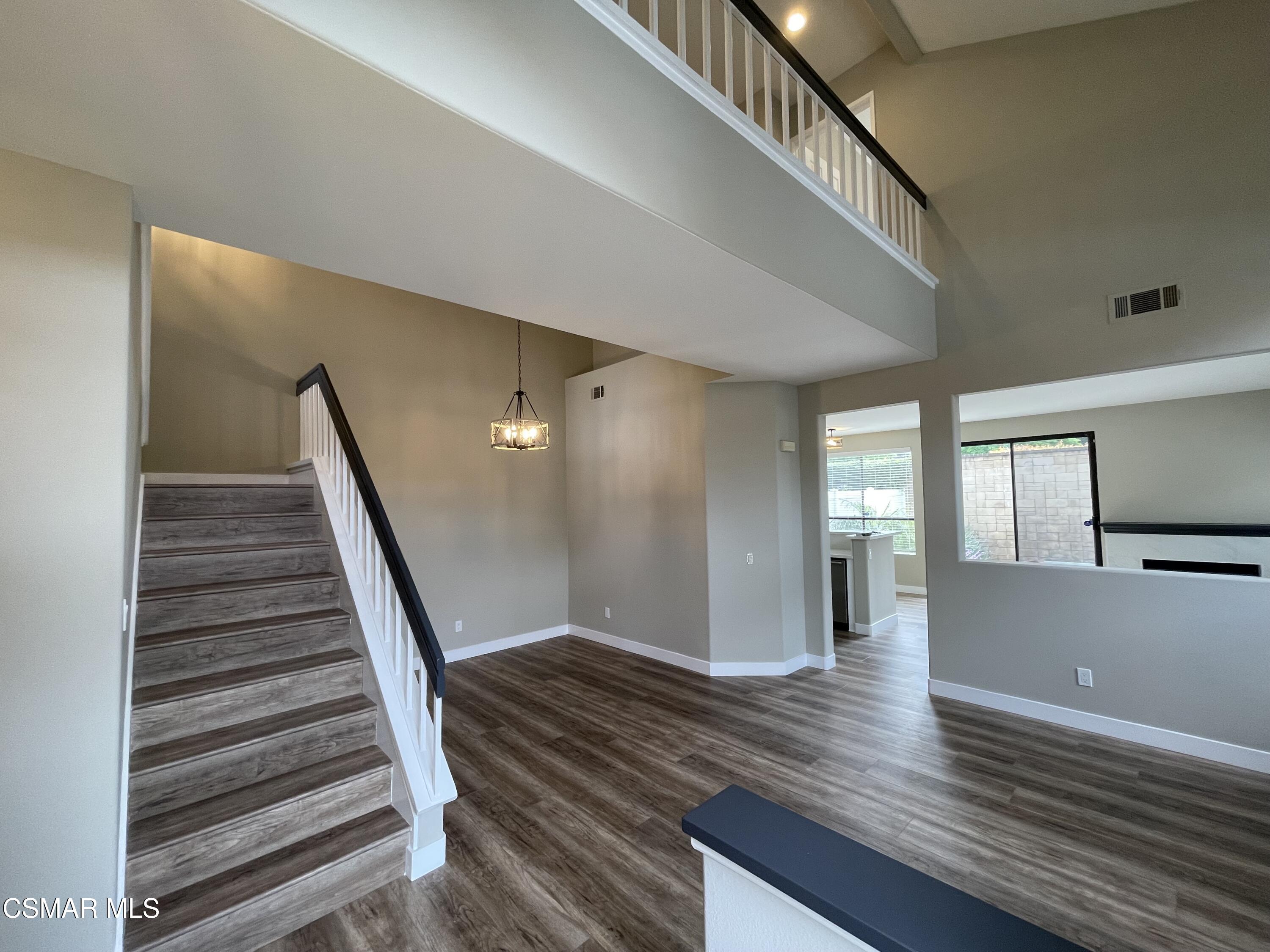 429 Dante Way Oak Park, CA 91377 - Photo 4 of 18 a view of a hallway with wooden floor and staircase