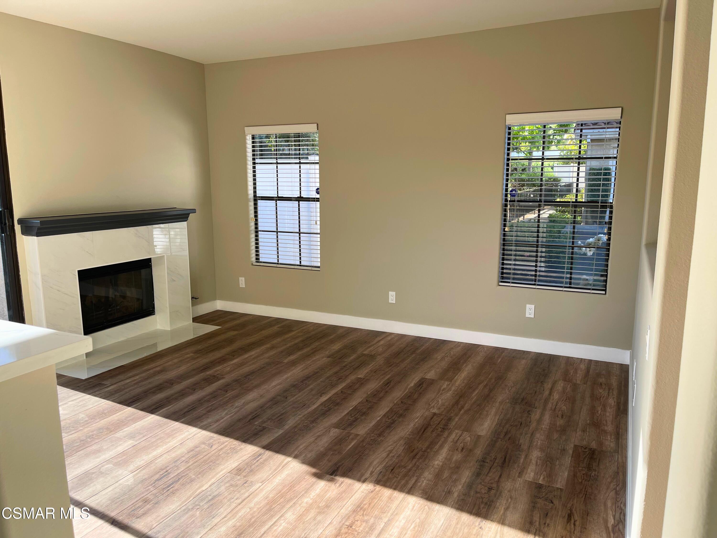 429 Dante Way Oak Park, CA 91377 - Photo 8 of 18 a view of an empty room with wooden floor fireplace and a window