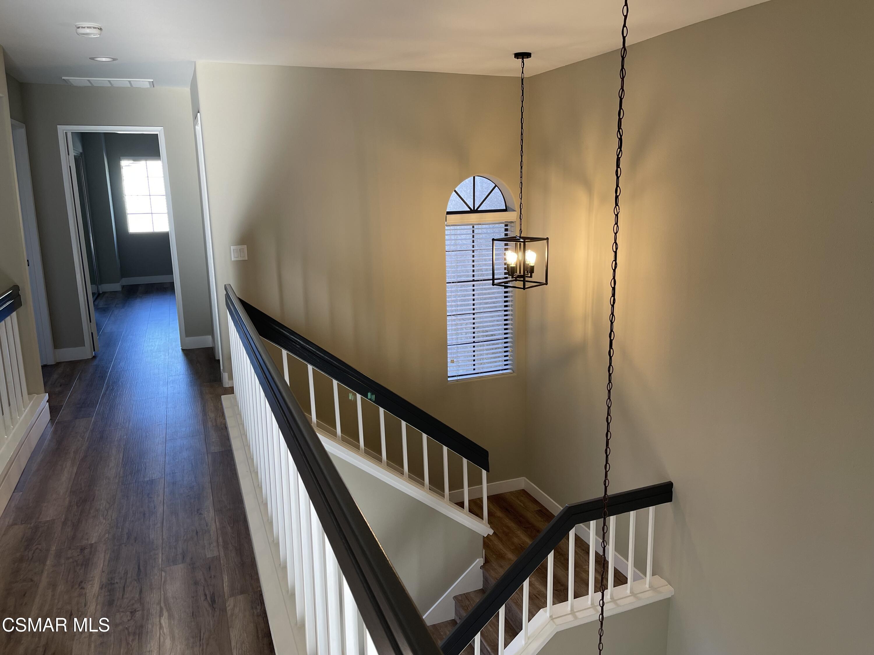 429 Dante Way Oak Park, CA 91377 - Photo 9 of 18 a view of a hallway with wooden floor and staircase