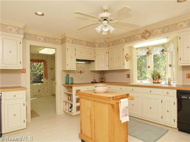 6102 Pintail Court Oak Ridge, NC 27310 - Photo 8 of 16 Kitchen. Amazing kitchen with cabinets galore. Laundry room with pantry, utility closet, sink and cabinets is adjacent to the kitchen.