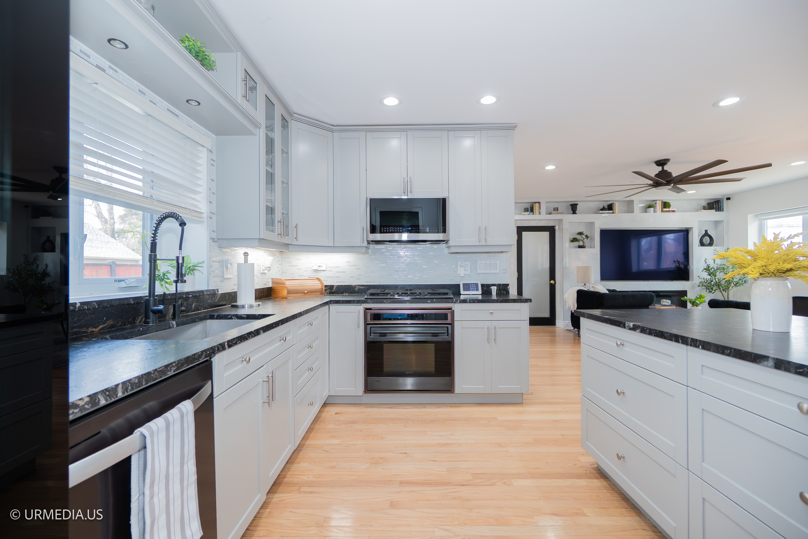 7100 North Sioux Avenue Chicago, IL 60646 - Photo 12 of 49 a kitchen with stainless steel appliances granite countertop a stove top oven a sink and a microwave