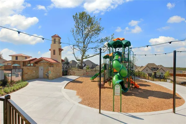 a childrens park with lots of swings and slides