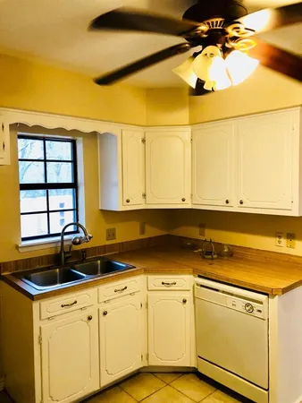 a kitchen with a sink cabinets and window